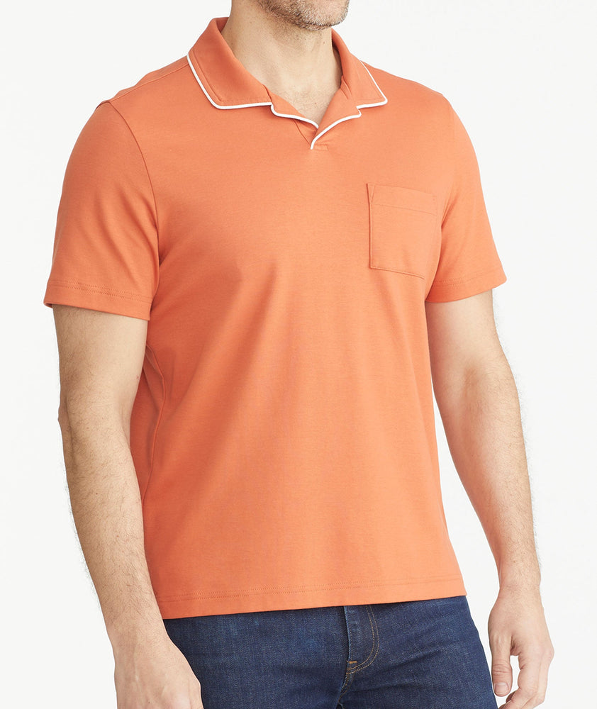 Model is wearing UNTUCKit orange Tipped Johnny Collar Polo.