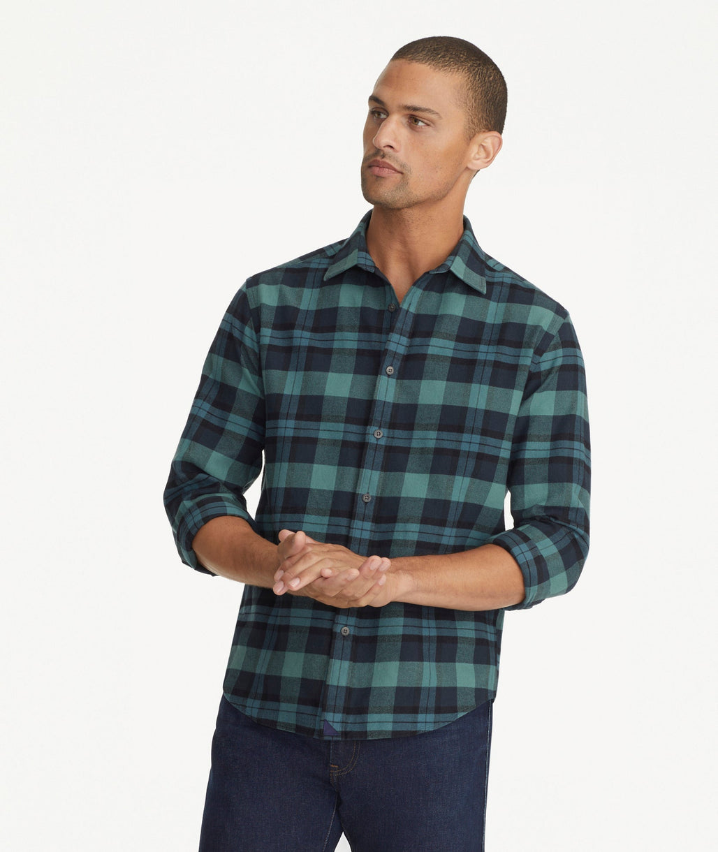 Model is wearing UNTUCKit Flannel Azedo Shirt in Teal & Navy Plaid.