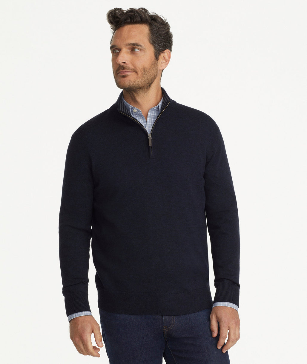 Model is weraring UNTUCKit Belguardo quarter zip in navy.