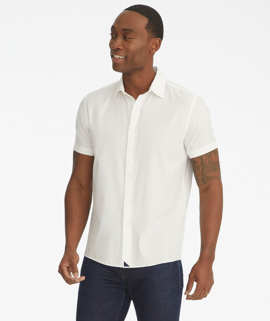 Model is wearing UNTUCkit white Briscoe short-sleeve button down.