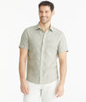 Model is wearing UNTUCKit Olive Wrinkle-Resistant Linen Short-Sleeve Cameron Shirt.
