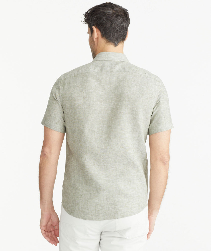 Model is wearing UNTUCKit Olive Wrinkle-Resistant Linen Short-Sleeve Cameron Shirt.