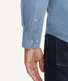 Model is wearing UNTUCKit Caprone Cord Shirt in Faded Blue.