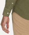 Model is wearing UNTUCKit Caprone Cord Shirt in green.