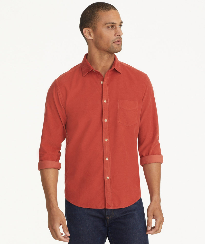 Model is wearing UNTUCKit Caprone Cord Shirt in Burnt Red.