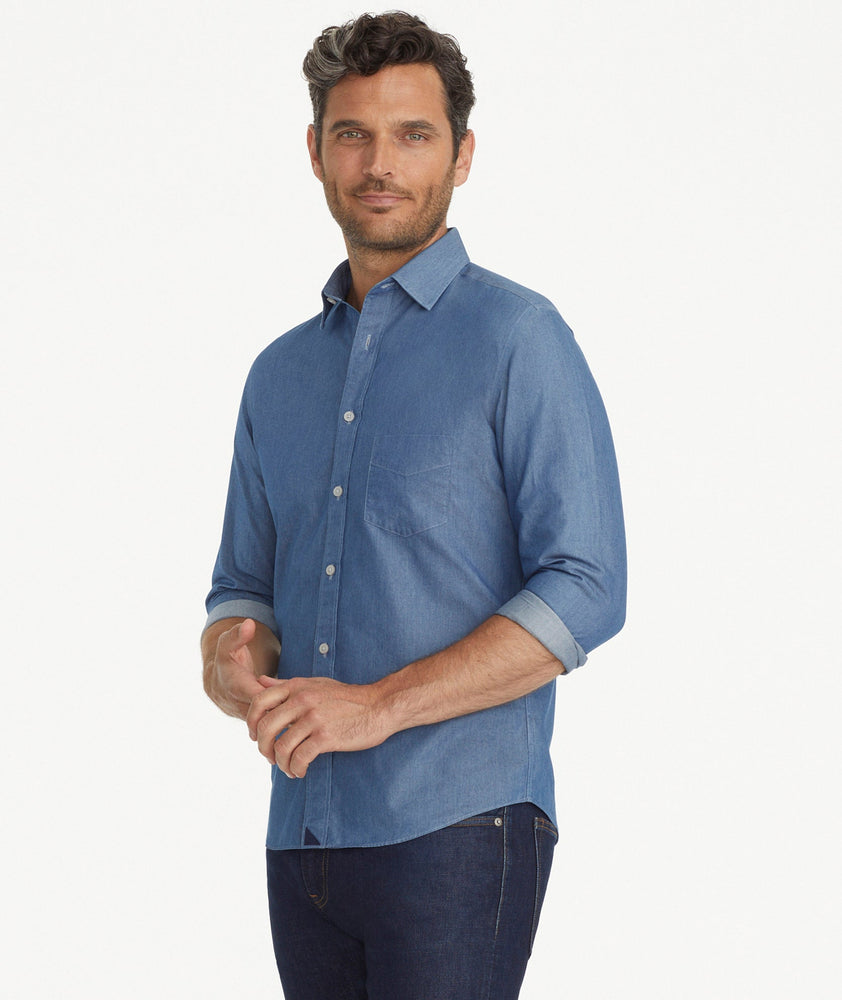 Model is wearing UNTUCKit Wrinkle-Free Cinzano Shirt in Light Blue Chambray.