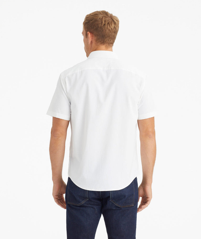 Model wearing an UNTUCKit White Wrinkle-Free Performance Short Sleeve Gironde Shirt