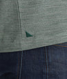 Model wearing an UNTUCKit Dark Green No Sweat Heathered Polo