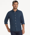 Model is wearing UNTUCKit Wrinkle-Free Veneto Shirt in Textured Teal.